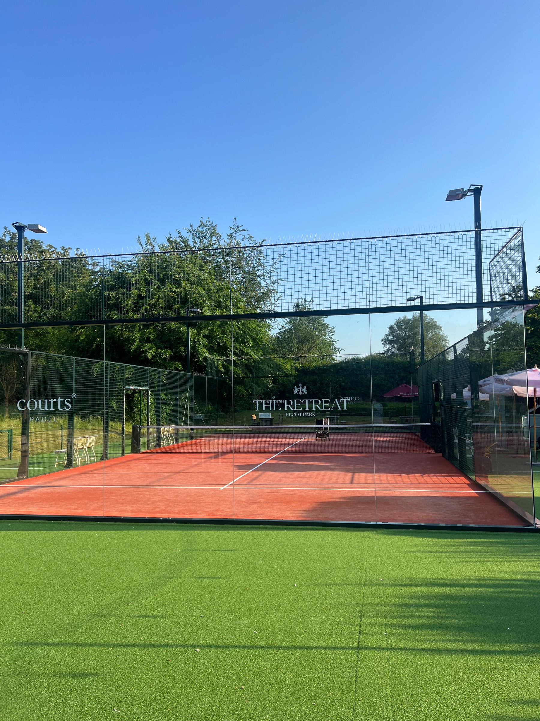 Two padel rackets and a ball on the court