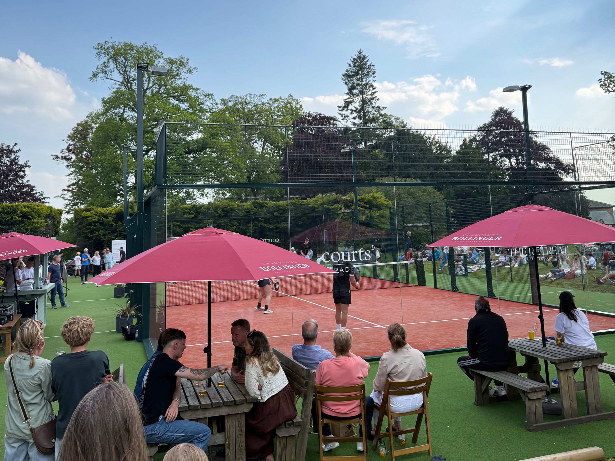 Padel racket and ball on a sunlit court